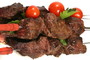 hot grilled beef meat with tomatoes over white