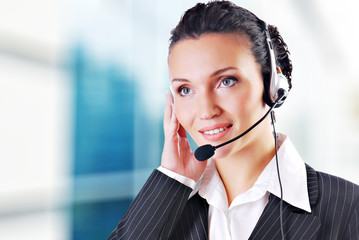 Woman wearing headset in office; could be receptionist