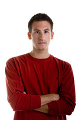 A young man in a red shirt with arms crossed isolated on white