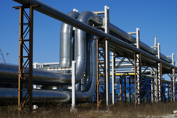 industrial pipelines on pipe-bridge against blue sky