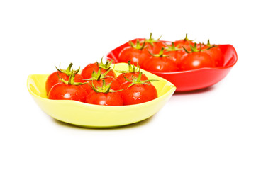 Wet whole tomatos arranged isolated on white.