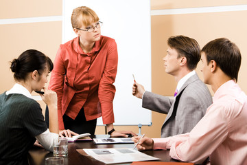 Teacher listening explanation of confident businessman