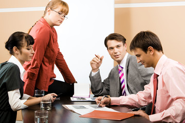 Portrait of successful team listening to young man