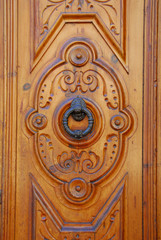 View of a doorknocker in a wooden door