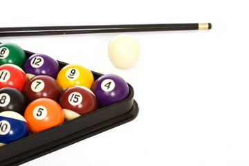 Billiard balls and a cue on white