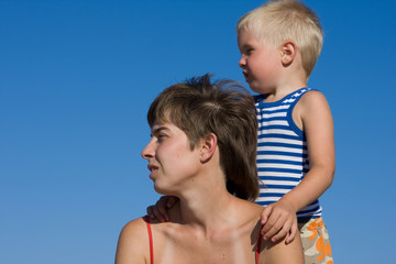 Fototapeta na wymiar Mother and son on blue sky background