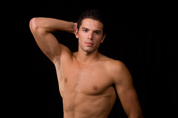 Fototapeta premium young sensual man on a black background