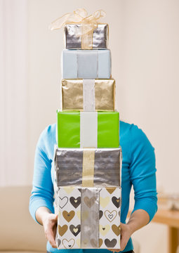 Generous Woman Carrying Stack Of Festive Birthday Gifts