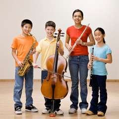 Confident musicians holding saxophone, cello, flute and clarinet © AVAVA