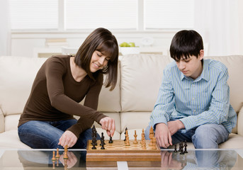 Friends playing chess in livingroom