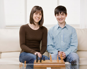 Friends playing chess in livingroom