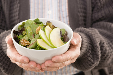 Man holding fresh, wholesome fruit salad - Powered by Adobe