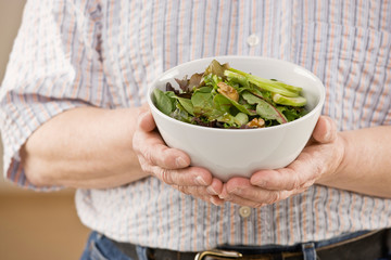Man holding fresh, wholesome fruit salad