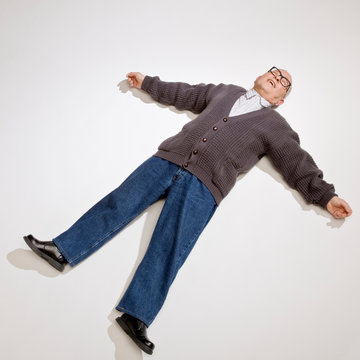 Exhausted Man Laying On Ground With Arms Outstretched