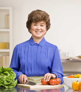 Housewife preparing wholesome salad in kitchen for dinner