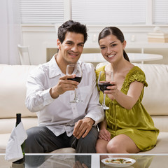 Couple toasting and drinking red wine celebrating anniversary