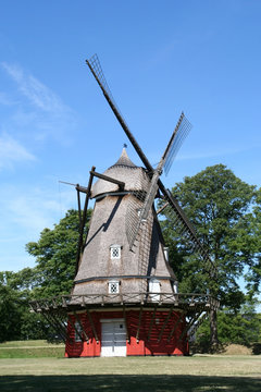 Red windmill surrounded by trees in Copenhagen