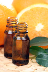 bottles of essential oils and some resh oranges
