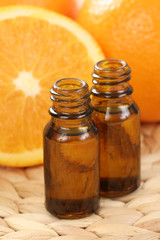 bottles of essential oils and some resh oranges