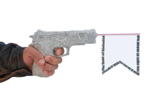 hand with fire a shot newspaper pistol and flag. fake