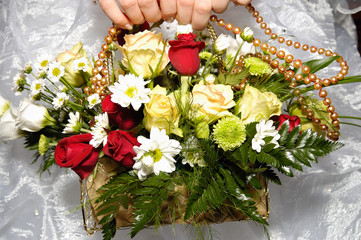 Bride's hands holding wedding bouquet