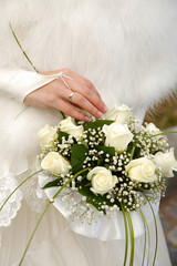 Bride's hands holding wedding bouquet