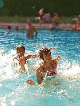 Kids Playing In The Swimming Pool