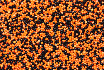 Background of orange and black candy sprinkles