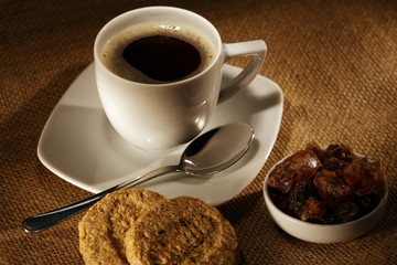coffee cup with fresh beans and cookies.