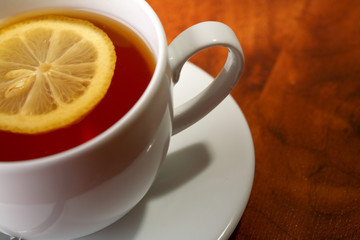 Hot teacup with lemon.