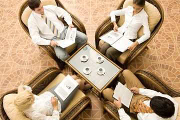 View from above of business people in armchairs