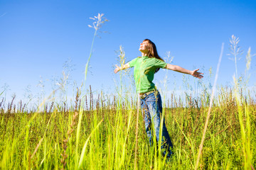 Happy young woman enjoying summer.