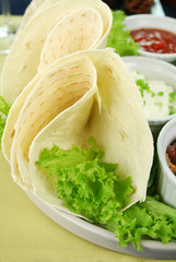 Mexican vegetarian platter with tortillas and sour cream