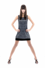 Beautiful woman in short dress poses over white