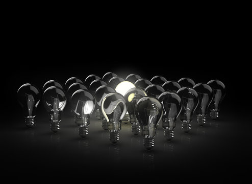 gropu of light bulbs with one shining