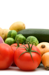 red tomato and vegetables on white background