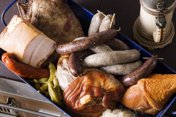 Meat, sausages, white puddings, bacon and a vintage beer mug