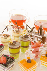 Tea with colorful confectionery on white background.