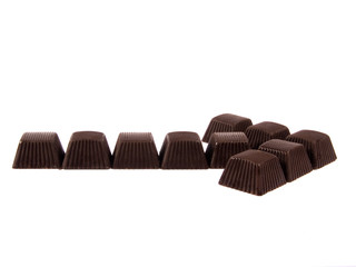 Chocolates composed in arrow on a white background