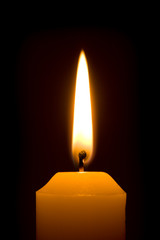 Macro of burning candle isolated on black background