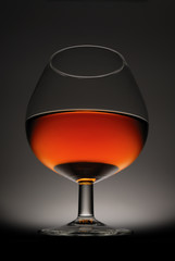 Glass of cognac on a black background