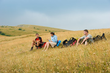 Hikers have a rest on a hillside