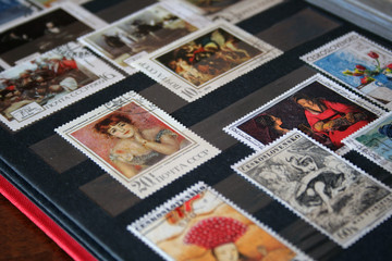 Postage stamps in red album