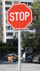 A Stop sign in the city. Shallow depth of field.