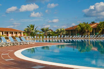Fototapeta na wymiar Resort swimming pool under a clear tropical sky.