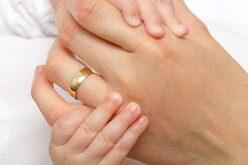 mother hand holding a new born baby hand