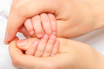 mother hand holding a new born baby hand