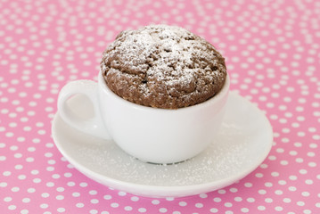 Dusted cupcake on pink polka dot background