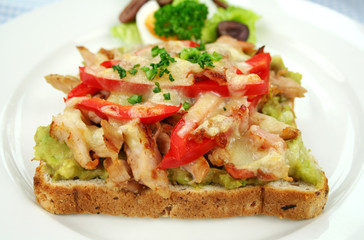 Grilled open chicken sandwich with avocado and cheese