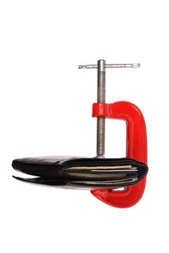Wallet squized with clamp isolated on white background